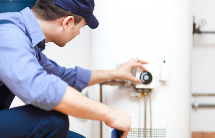 Plumber repairing an hot-water heater